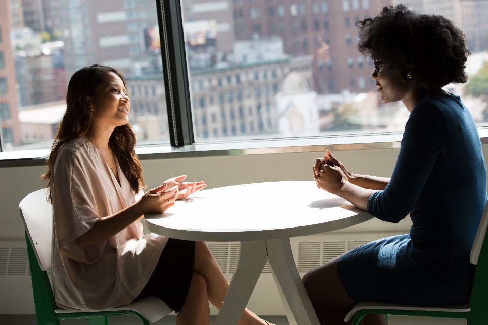 Advisor and client discussing loan paperwork across a table